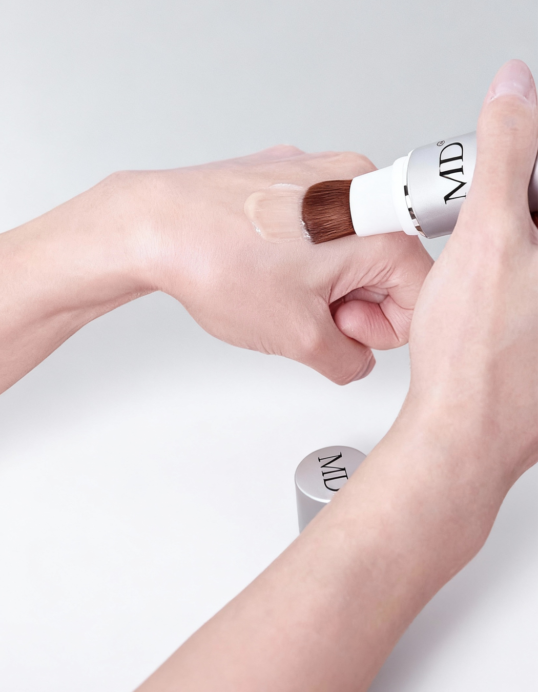 Close‑up of MD® Hair Follicle Energizer precision brush applicator for targeted scalp application