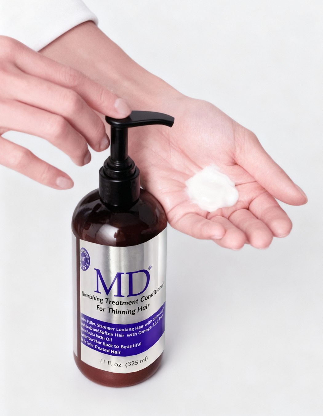 Lifestyle photo of MD® Revitalizing Treatment Conditioner being pumped into hand – nutrient-rich formula for thinning hair, scalp hydration, and hair repair, part of the MD Hair system